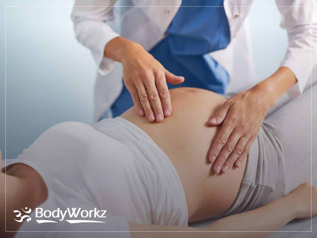 Chiropractor providing Chiropractic Care to a pregnant woman for pain relief and comfort