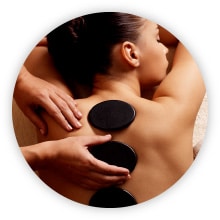 Woman recieving hot stone massage therapy